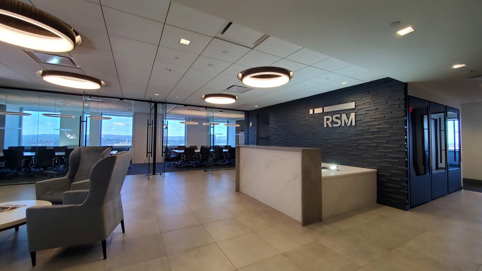 Natural light filters through glass walled conference room affording panoramic views of the hills of Hartford and beyond.